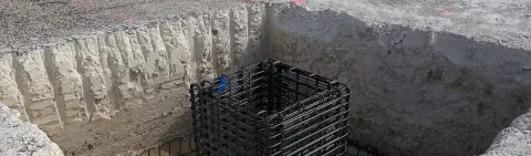 Cage d'armature en attente de coulage dans une fondation, chantier de génie civil URANO